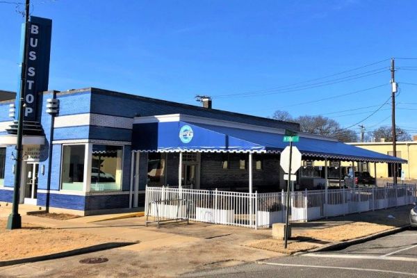 blue fabric canopy over outdoor dining patio at Bus Stop restaurant