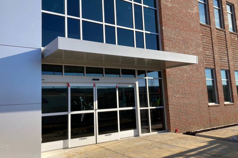 Suspended metal canopy entryway