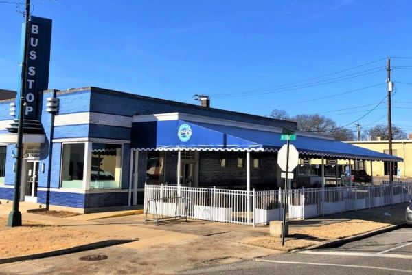 blue fabric canopy over outdoor dining patio at Bus Stop restaurant