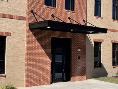 Suspended metal door canopy